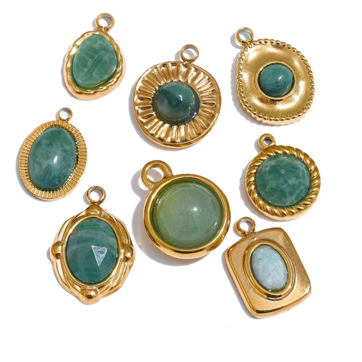 Gold-framed green gemstone pendants on a white background .