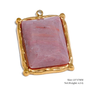 Pink stone pendant with gold frame on a white background