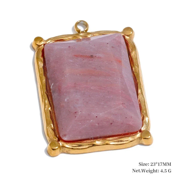 Pink stone pendant with gold frame on a white background