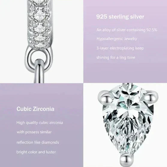 Sparkling Hoop Earrings - TM & CO. JEWELS - Silver pendant with cubic zirconia on a purple background.