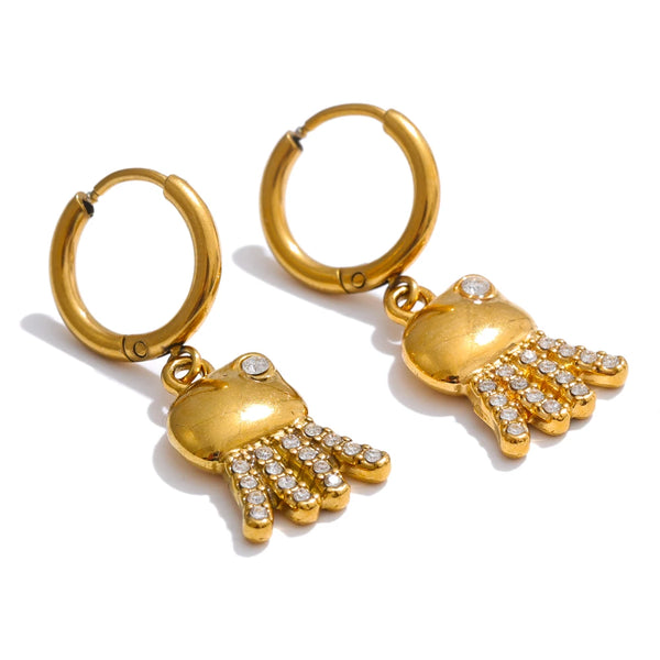 Gold hoop earrings with hamsa hand charms on a white background