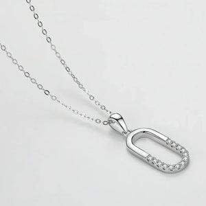 Silver necklace with a unique pendant on a light gray background