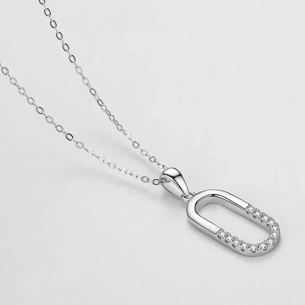 Silver necklace with a unique pendant on a light gray background