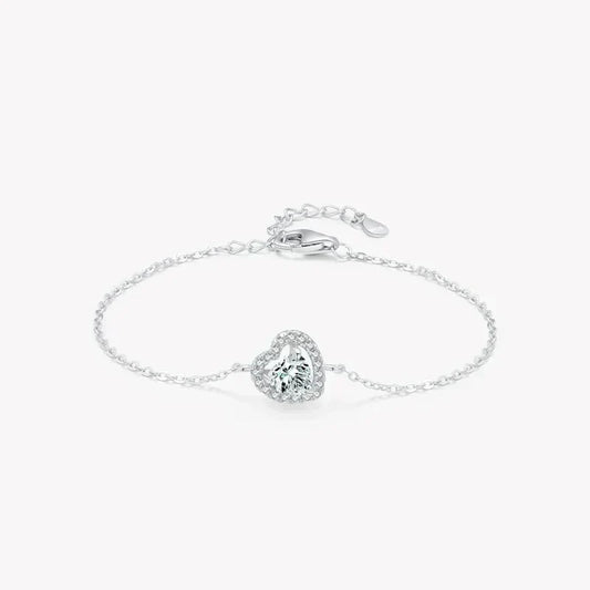 Sterling silver bracelet with heart-shaped gemstone and adjustable chain on white background