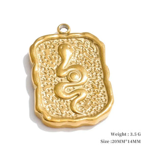 Gold pendant with intricate design on a white background