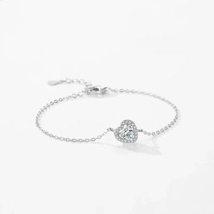 Sterling silver bracelet with heart-shaped gemstone and delicate chain on white background