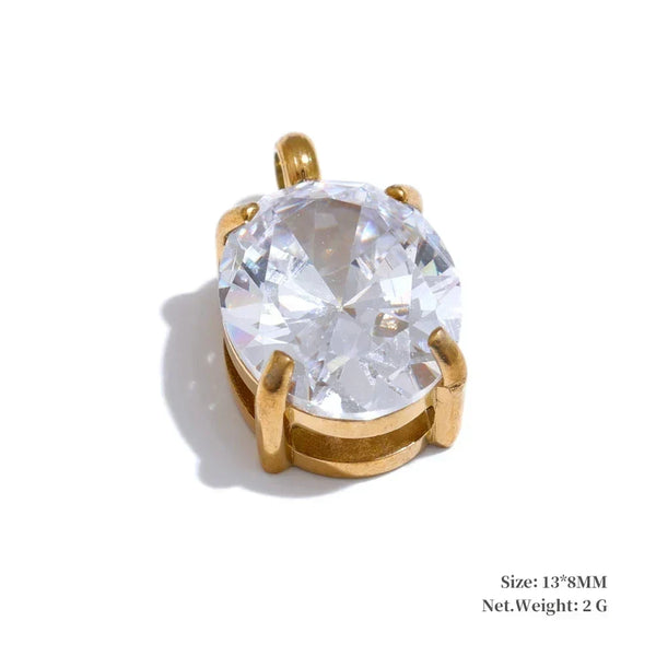 Gold pendant with a large clear gemstone on a white background