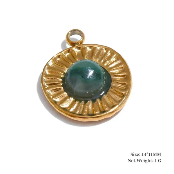 Gold pendant with a green gemstone on a white background