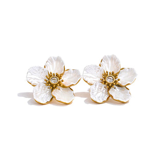 Floral earrings with gold accents on a white background.