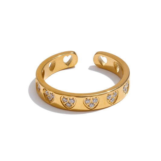 Gold ring with heart designs and small diamonds on a white background