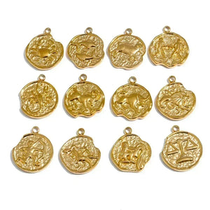 Gold zodiac pendants arranged in a 4x3 grid on a white background.