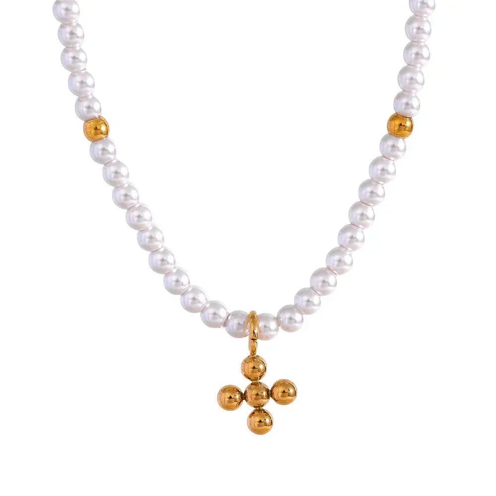 Pearl necklace with a gold pendant on a white background.