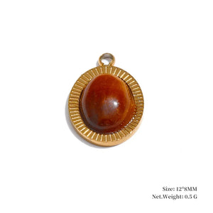Gold pendant with a brown stone on a white background