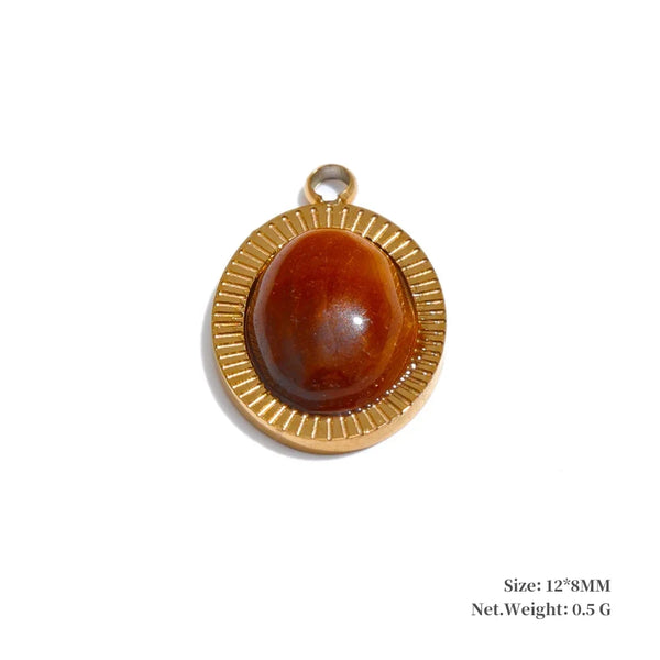 Gold pendant with a brown stone on a white background
