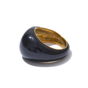 Black and gold ring on a white background