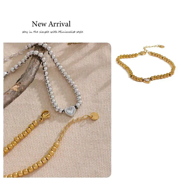 18K gold-plated beaded bracelet with a central heart-shaped charm and adjustable clasp