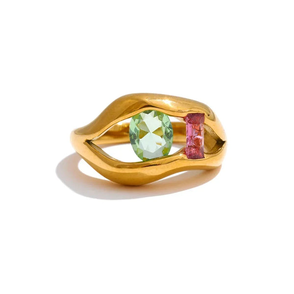 Gold ring with green and pink gemstones on a white background.