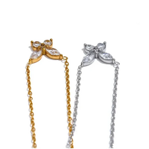 Two butterfly-shaped hair accessories, one gold and one silver, on a white background.