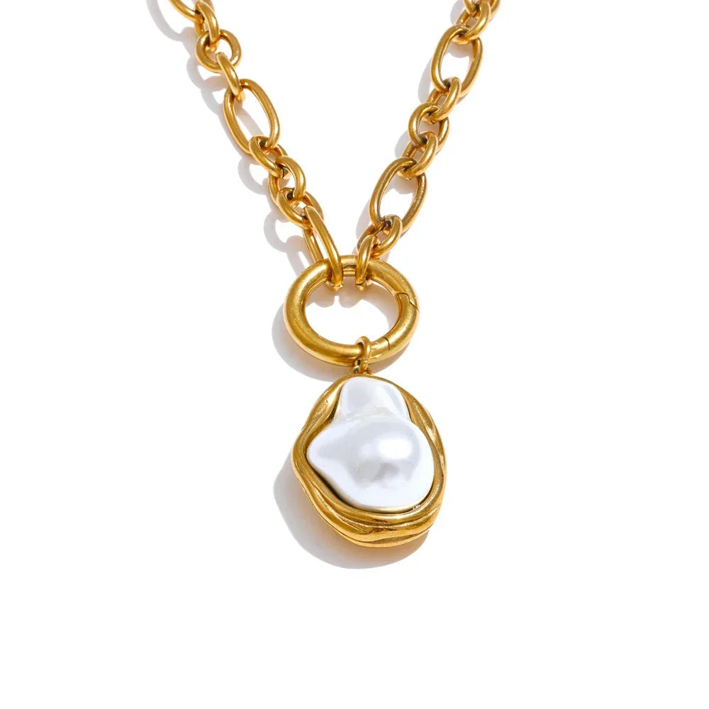 Gold necklace with a pearl pendant on a white background.