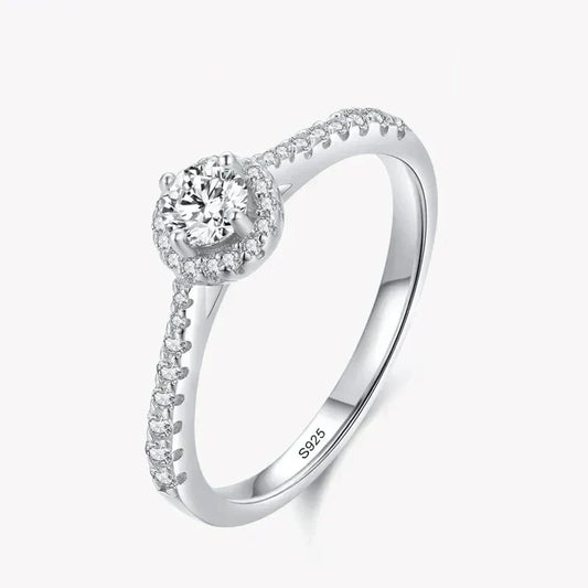 Sterling silver ring with round center cubic zirconia and pavé band on white background