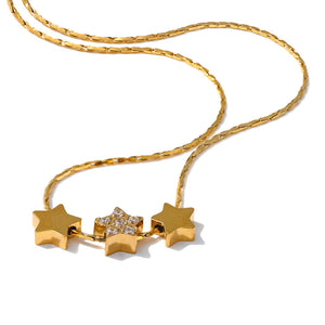 Gold necklace with star-shaped pendants on a white background