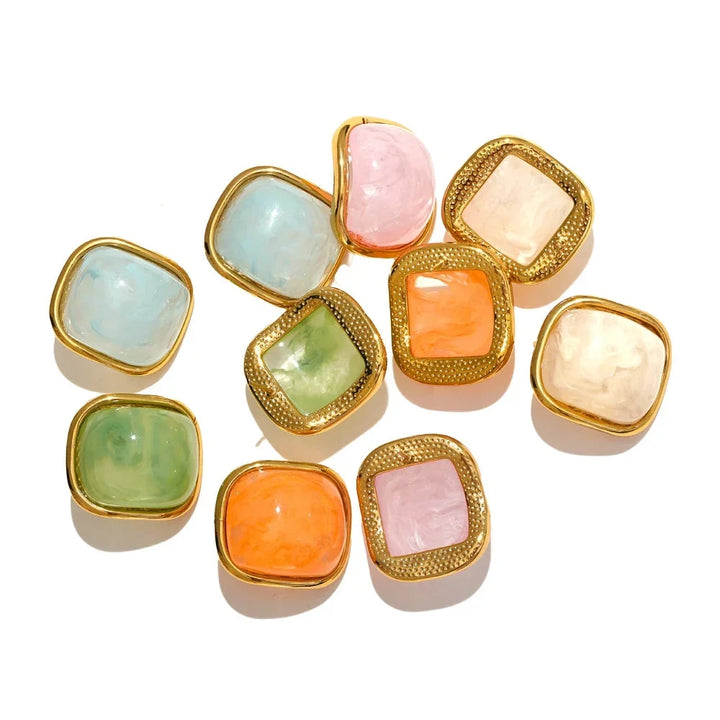 Set of colorful square stones with gold borders on a white background
