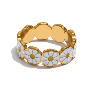 Gold ring with white daisy flowers on a white background