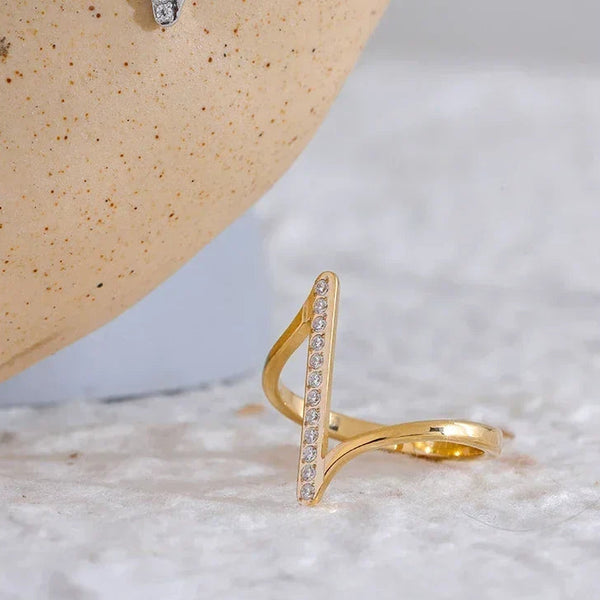 Gold and silver adjustable rings with vertical CZ accents on textured background
