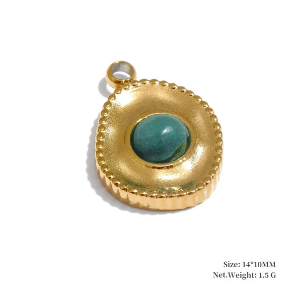 Gold pendant with a green gemstone on a white background