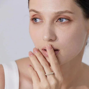 Woman wearing gold-plated silver ring with pavé stones, elegant minimal jewelry style