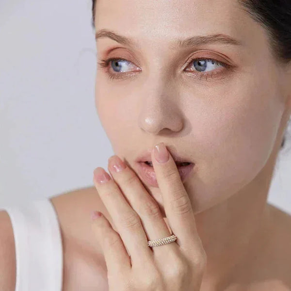 Woman wearing gold-plated silver ring with pavé stones, elegant minimal jewelry style
