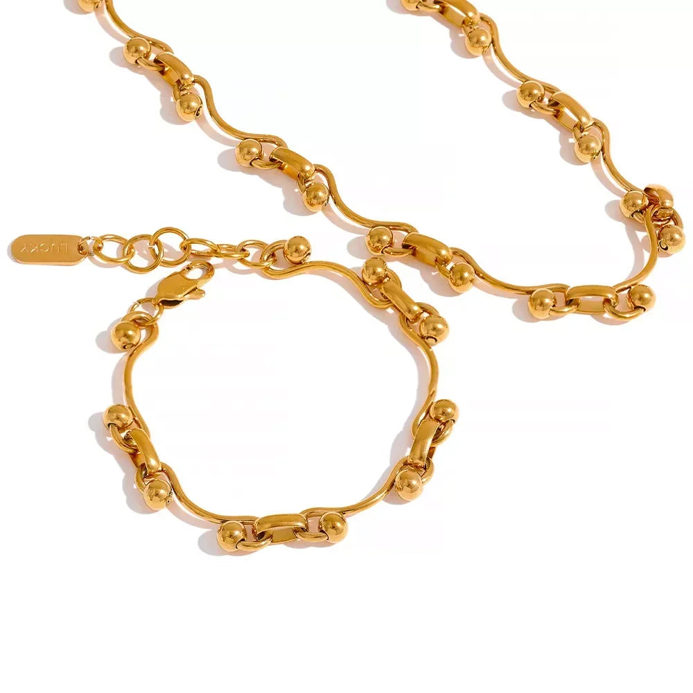 Gold chain necklace on a white background.