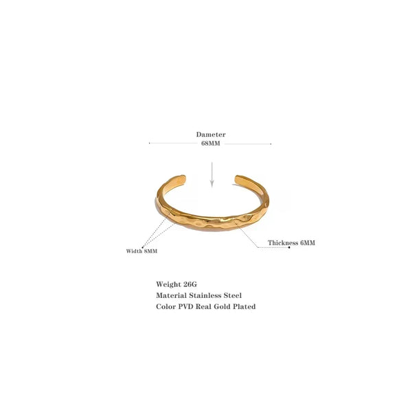 Gold-plated stainless steel cuff bracelet with hammered texture, 68mm diameter, 8mm width.