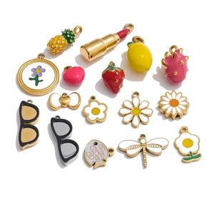 Collection of colorful charms including fruits, flowers, and accessories on a white background
