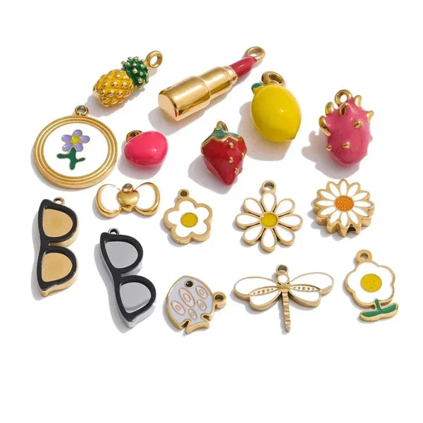 Collection of colorful charms including fruits, flowers, and accessories on a white background