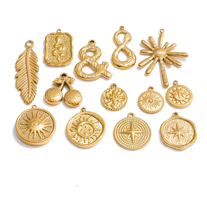 Collection of gold pendants on a white background.