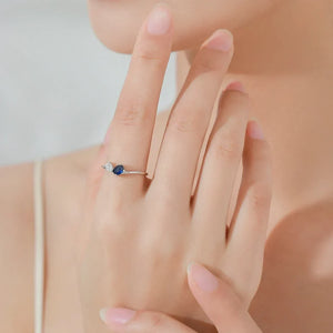 Woman wearing the Capri Twilight Jewelry Set featuring a blue gemstone ring and bracelet.