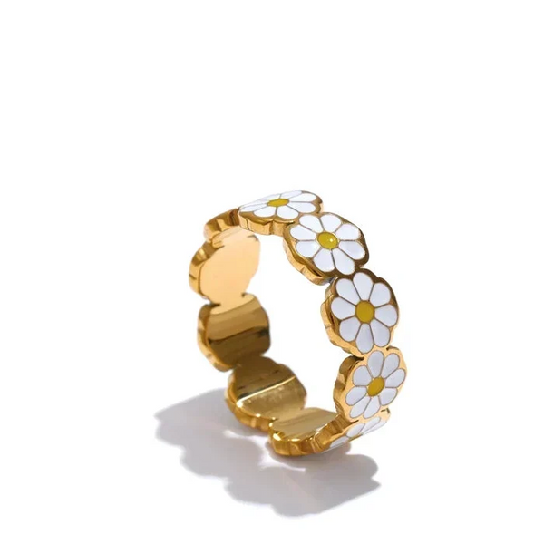 Gold ring with white daisy flowers on a white background