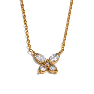 Gold butterfly necklace with clear stones on a white background.
