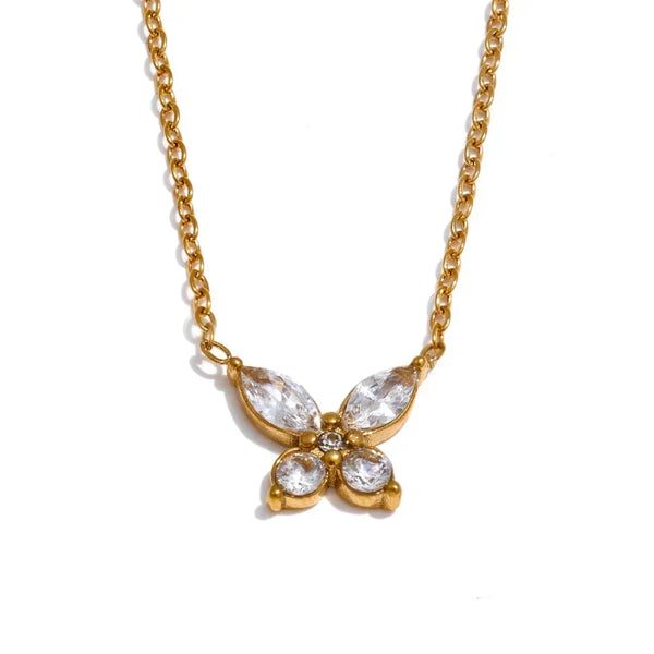 Gold butterfly necklace with clear stones on a white background.