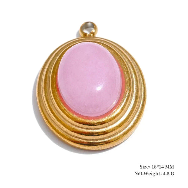 Gold pendant with a pink stone on a white background