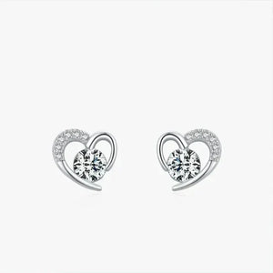 Heart-shaped earrings with clear gemstones on a white background