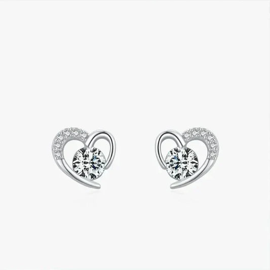 Heart-shaped earrings with clear gemstones on a white background