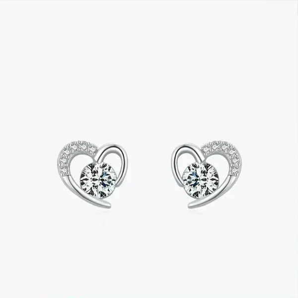 Heart-shaped earrings with clear gemstones on a white background