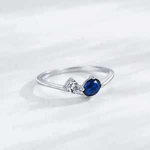 Silver ring with a blue gemstone on a white background