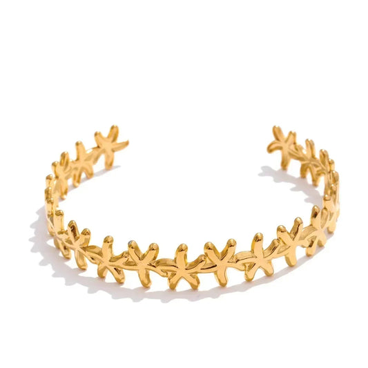 Gold headband with star designs on a white background