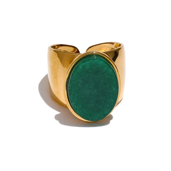 Gold ring with a green stone on a white background