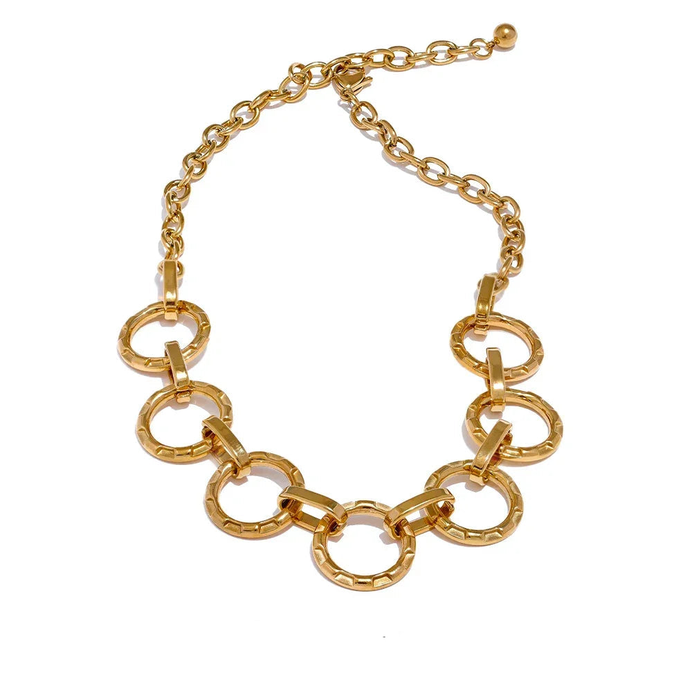 Gold chain necklace on a white background.