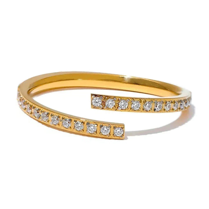 Gold open ring with diamond stones on a white background