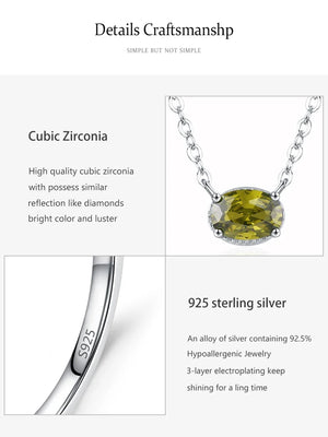 Silver necklace with a cubic zirconia pendant on a white background, featuring text details about the cubic zirconia and 925 sterling silver.